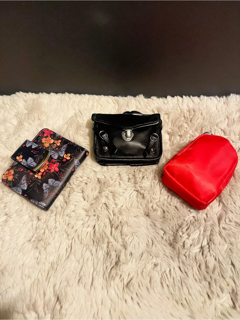 Three piece bundle of two coin, purses, and one small wallet